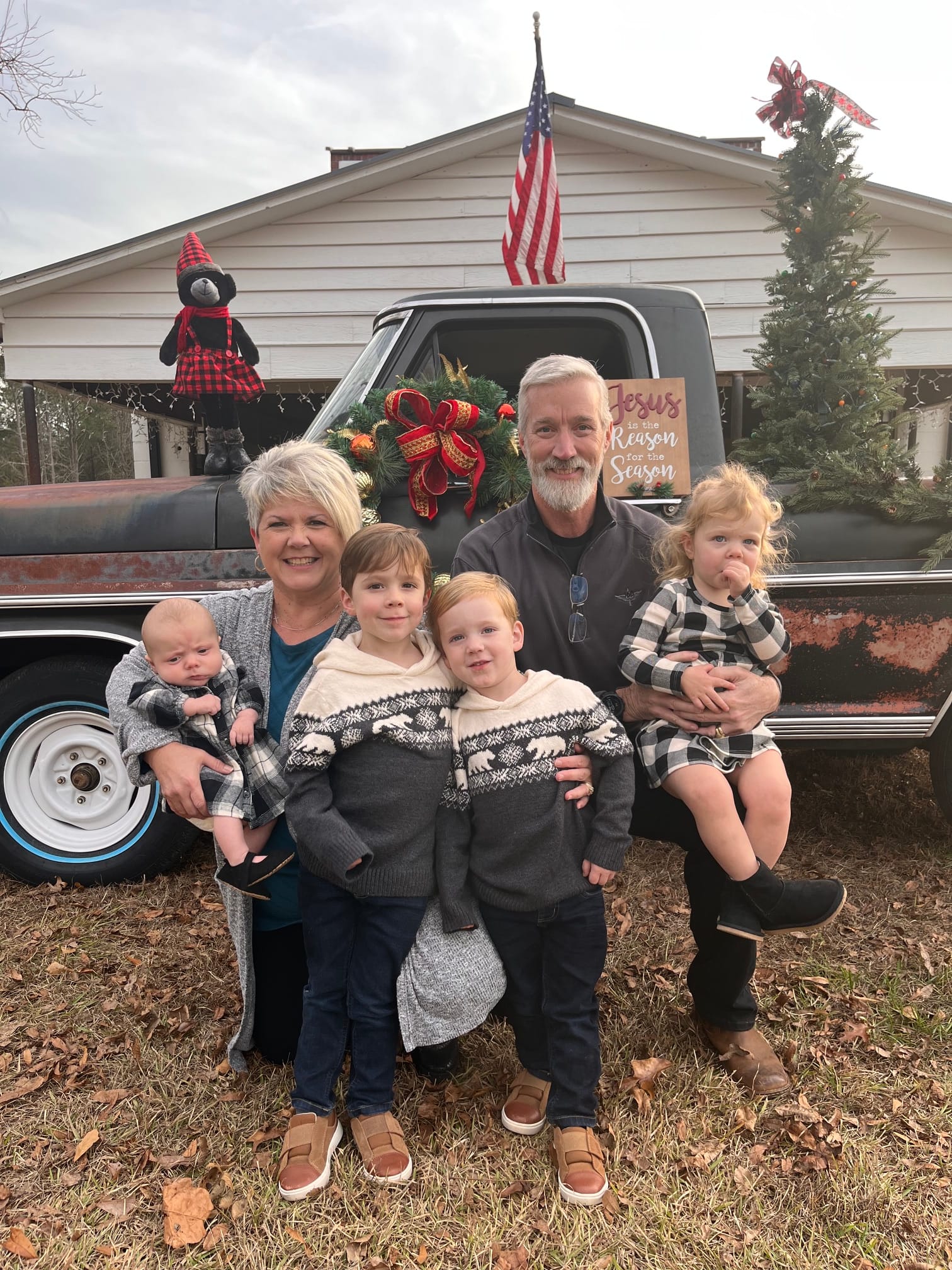John and Lashelle Thompson with their grandchildren by the vintage truck