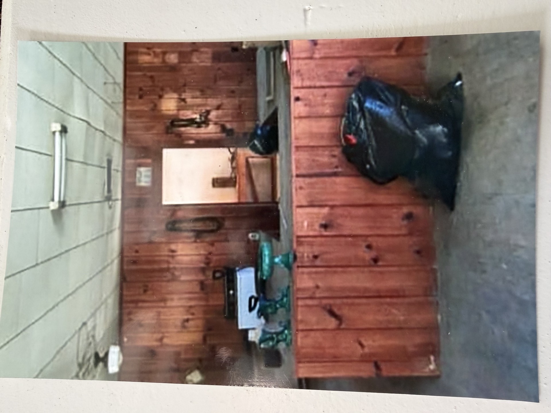 The original store counter before restoration — wood paneling, fluorescent lights, decades of dust